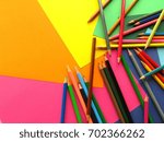 Small photo of Orderless colored pencils on colorful background, pink, orange, yellow, green, blue