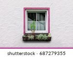 Small photo of Tawdry window on a house front with pink color accents