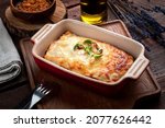 Small photo of Lasagna with meat and tomato sauce baked in the oven in a ceramic dish. Homemade bolognese lasagna, rustic style