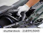 mechanic wearing white gloves checks the radiator hose. safety concept The concept of checking the condition of the car before leaving
