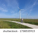 Woman On Electric Bicycle With...