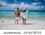 couple of men and woman mid age on the beach of Curacao, Grote Knip beach Curacao Dutch Antilles Caribbean. on a tropcial beach with white sand