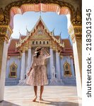 Small photo of Wat Benchamabophit temple in Bangkok Thailand, The Marble temple in Bangkok. Asian woman with hat visiting temple in Bangkok