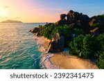 Anse Source d'Argent beach, La Digue Island, Seychelles, Drone aerial view of La Digue Seychelles bird eye view. of tropical Island, couple men and woman walking at the beach at a luxury vacation