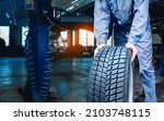 Small photo of Seasonal tire changeover in auto service. Tire swap background with copy space. Winter tire storage.