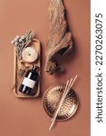 Small photo of Scented oil for home with rattan sticks, luxury home perfume with woody and flowers fragrance. Vertical, top view photography.