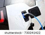 The process of charging an electric vehicle. Electric car socket.