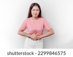 An Asian woman is hungry or having menstruation or stomach ache and touching her belly 