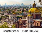 Mexico. Basilica of Our Lady of Guadalupe. Cupolas of the old basilica and cityscape of Mexico City on the far