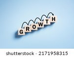 Small photo of Growth business performance progress and increasing success concept wooden blocks and arrow moving up ladder