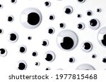 Small photo of Top view of many shaky plastic doll eyes on white background.