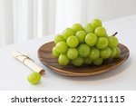 Shine Muscat grapes on a white background. White grapes.