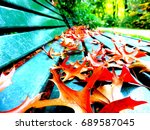Fall Leaves On A Park Bench