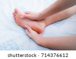Small photo of Woman has numbness on her right foot. Cramp, Spasm, Twinge, Sprain