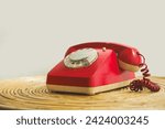 Small photo of An old telephone with rotary dial, Red vintage phone. rotary telephone on table.