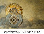 Small photo of clutch plate and Clutch Cover expire on dirty background.There are rust stains.maintenance services clutch.
