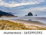 Beach grass and Haystack Rock and city of Canon Beach, Oregon