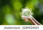Small photo of Monlikul's Clean Hydrogen Energy in the concept of environment environmentally friendly industry nature and alternative energy Future climate-friendly energy Connect icon on hand on green background