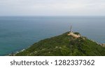 Small photo of Aerial view of Dai Lanh beach and Mui Dien light house in a sunny day, MuiDien, Phu Yen province - The eastermost of Vietnam. Stock photo image top view of Mui Dien lighthouse on fractured rocky cliff
