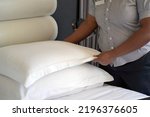 Hand of african woman maid making bed in hotel room. Housekeeper Making Bed
