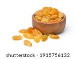 Yellow Raisins in wooden bowl isolated on white background.