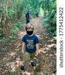 Small photo of Pugu Hills, Dar es Salaam, TZ - 07 12 2020: boy wearing mask walking in the forest during Corona