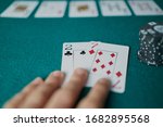 Small photo of Bad poker gamble or unlucky hand concept with player going all in with 2 and 7 (two and seven) offsuit also called unsuited, considered the worst hand in poker preflop (before the flop is revealed)