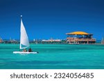 Small photo of Sailing catamaran sail boat in clear caribbean sea water
