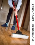 Image of Mopping the floor using a plastic squeegee | Freebie.Photography