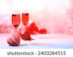 Festive alcoholic cocktail Mimosa with cranberries in glasses and love hearts, Valentine's Day concept, alcoholic drinks at a party, bar and restaurant advertising, selective focus