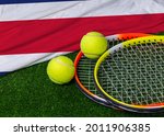 A Tennis Racquet With Tennis...