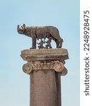 Small photo of Capitoline Wolf against blue sky, bronze sculpture of the mythical she-wolf suckling the infant twins Romulus and Remus. A scene from the legend of the founding of Rome. Rome, Lazio, Italy.