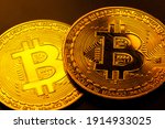 Two shiny gold bitcoin coins macro, extreme closeup. Golden cryptocurrency symbol up close, decentralized finance, digital assets wealth, bitcoin crypto currency market financial concept, trading