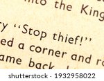 Small photo of Stop thief! Single text line focus, words in an old book dramatic macro extreme closeup Literature thievery, burglary, robbery, stealing and crime Thief symbol, abstract language quote concept, nobody