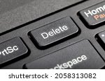 Small photo of Delete key, del button on a laptop keyboard, object macro, extreme closeup, detail. User file deletion, traces removal, erasing information, getting rid of digital data abstract concept, nobody