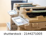 Copy shop copiers, photocopying point interior, two photocopiers copy machines objects closeup, detail, nobody. Photocopy archiving, scanning copying documents technology abstract concept, no people
