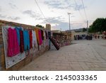 Small photo of Jaisalmer, Rajasthan, India - October 13, 2019 : Colourful ladies clothes are displayed for sale to tourists in market place at Jaisalmer city in the afternoon.