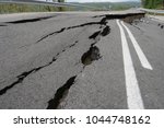 Small photo of Road collapses with huge cracks. Earthquake. International road collapsed down after bad construction. Damaged Highway Road. Asphalt road collapsed and fallen.