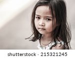 Small photo of Asian girl Sitting at the playground And joyless