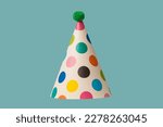 Bright and colorful birthday cap isolated on a green background. Holidays cocept. 