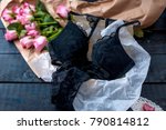 a set of underwear as a gift. Black lace. An intimate surprise on Valentine's Day. Bouquet of pink roses. Free space for text or postcards

