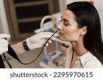 Small photo of ENT doctor using fibrolaryngoscope to examine and treat nose. ENT specialist diagnoses and treats larynx and pharynx, such as hoarseness, vocal cord nodules, tumors, infections, and inflammation
