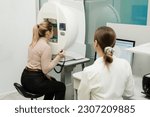 Small photo of Perimetry eyes test for early sign of glaucoma of woman patient of ophthalmology clinic. Perimetry visual field test for measure all areas of eyesight, including side, or peripheral vision