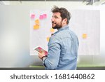 Young business man has an idea while creative brainstorming with sticky notes
