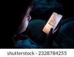 Small photo of A child using smart phone lying in bed late at night, playing games. Children's screen addiction and parent control concept. Child's room at night. Sensitive content on screen