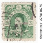 Small photo of JAPAN - 1908: An 5 yen green postage stamp depicting portrait of Empress Jingo. Empress Jingu was a legendary Japanese empress who ruled as a regent following her husband's death in 200 AD