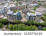 Aerial drone photo of the historic town of Shipley in the City of Bradford, West Yorkshire, England showing a Newley regenerated development of apartment buildings by the by the River Aire