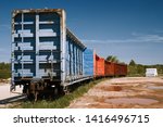 Small photo of Railroad freight cars on rural sidetrack.