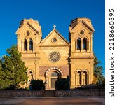 The facade of Cathedral Basilica of St. Francis of Assisi illuminated by the sun rays in Santa Fe, the capital of New Mexico