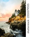 Small photo of Sunset over the lighthouse on the cliff. Dramatic seascape with Bass Harbor Head Light Station in Tremont, Acadia National Park, Maine